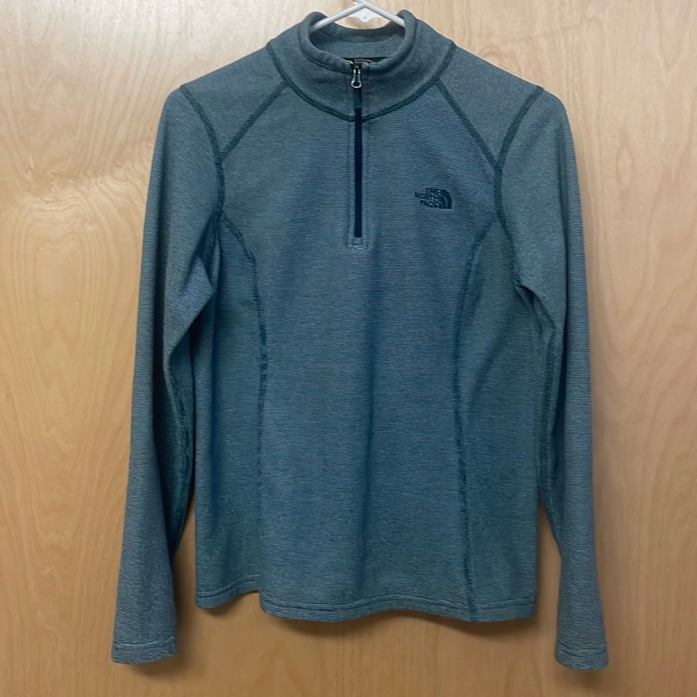 The North Face turquoise and white striped top. Long sleeved, 1/4 zip. No flaws.